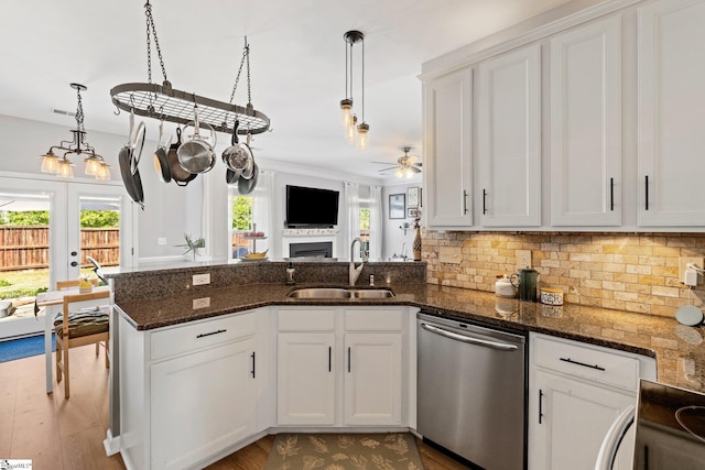 kitchen featuring dishwasher, a sink, ceiling fan, and a healthy amount of sunlight