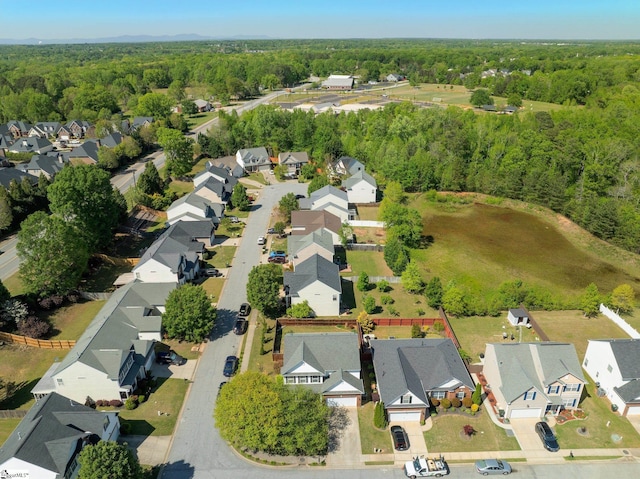 bird's eye view featuring a residential view and a wooded view