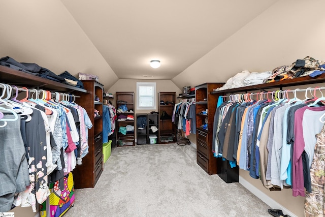 spacious closet with lofted ceiling and carpet