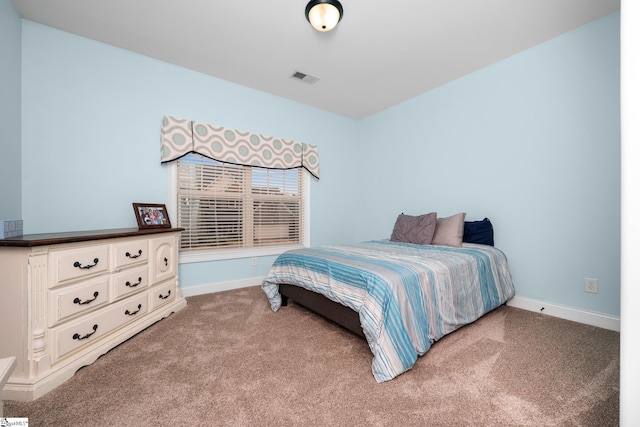 carpeted bedroom with visible vents and baseboards