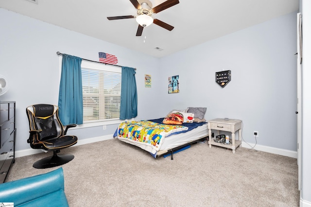 carpeted bedroom with visible vents, baseboards, and ceiling fan