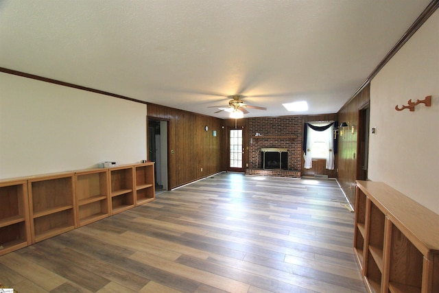 108 Dill Dr, Piedmont, SC 29673 - unfurnished living room with ornamental molding, a ceiling fan, a brick fireplace, and wood finished floors