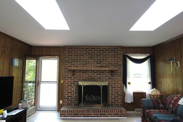 108 Dill Dr, Piedmont, SC 29673 - living area with visible vents, a skylight, wood finished floors, wooden walls, and a fireplace