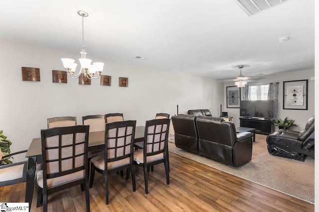 126 Rubin Ave, Anderson, SC 29624 - dining space featuring wood finished floors, visible vents, and ceiling fan with notable chandelier