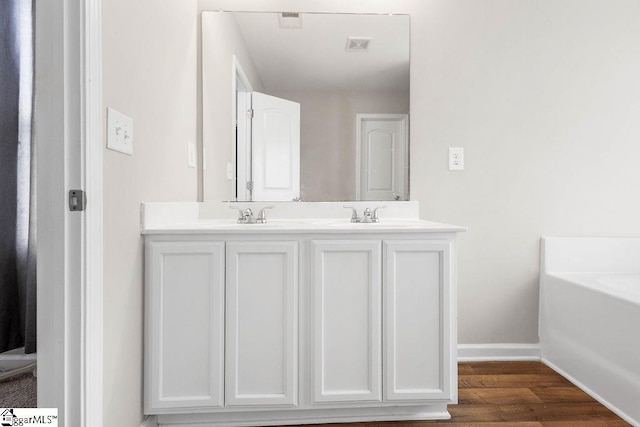 126 Rubin Ave, Anderson, SC 29624 - full bath featuring wood finished floors, a sink, a tub, double vanity, and baseboards