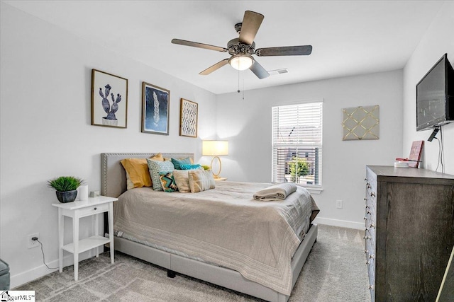 carpeted bedroom with ceiling fan, baseboards, and visible vents
