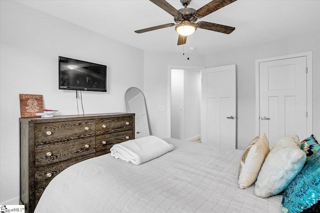 bedroom featuring baseboards and ceiling fan
