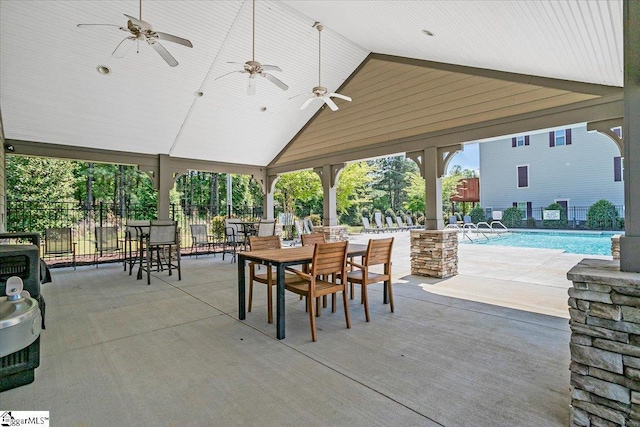 view of patio / terrace featuring fence, an outdoor pool, and ceiling fan