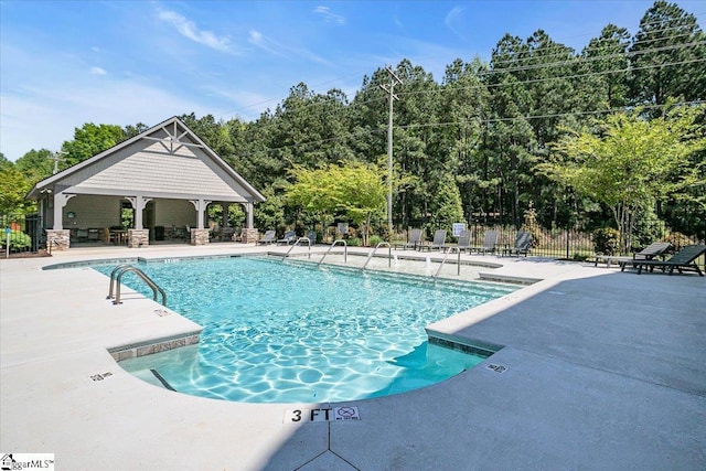 community pool featuring fence, a patio area, and a gazebo