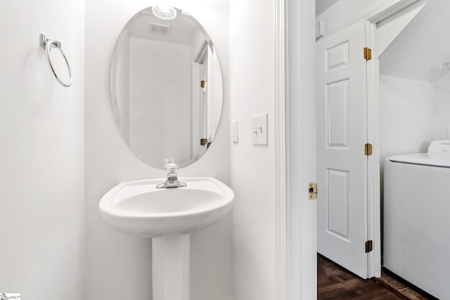 bathroom featuring wood finished floors and washer / clothes dryer