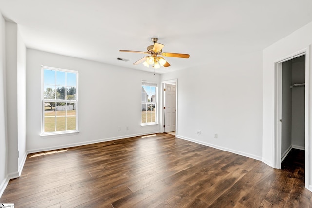 unfurnished bedroom featuring visible vents, baseboards, and dark wood-style floors