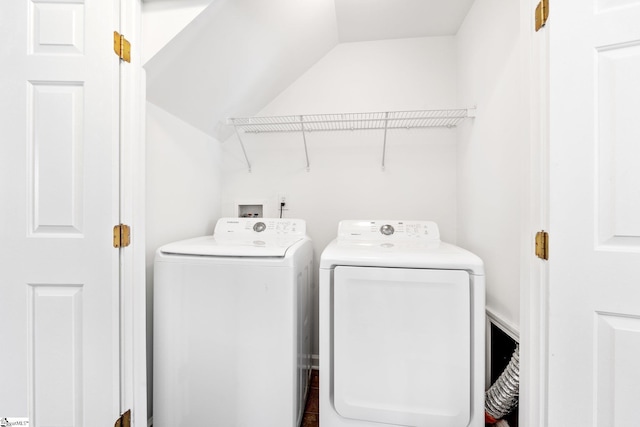 clothes washing area featuring washer and dryer and laundry area