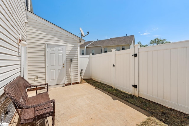 view of patio featuring a gate and fence