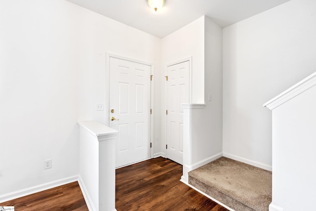 entryway with baseboards and wood finished floors