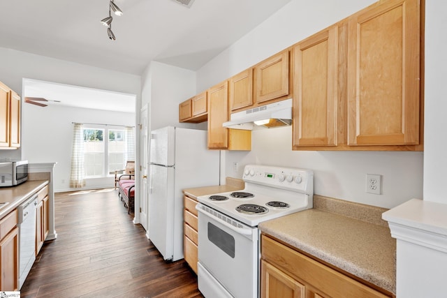 kitchen featuring under cabinet range hood, light brown cabinetry, white appliances, light countertops, and dark wood-style flooring