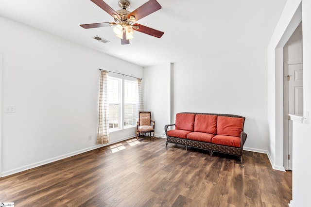 sitting room with baseboards, wood finished floors, visible vents, and ceiling fan
