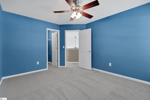 unfurnished bedroom with carpet, baseboards, and ceiling fan