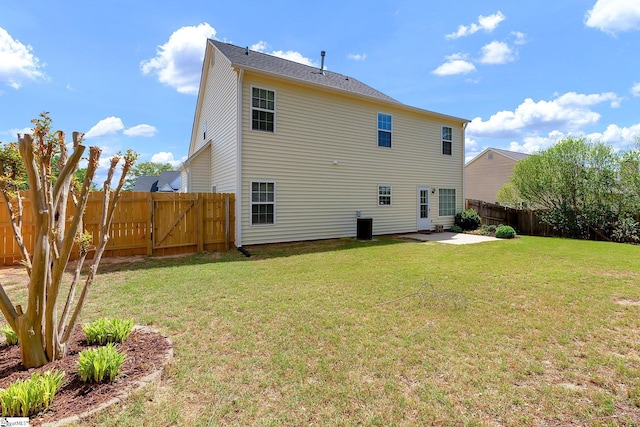 rear view of property featuring a fenced backyard, a gate, a yard, and a patio area