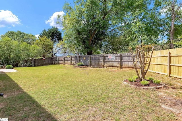 view of yard with a fenced backyard