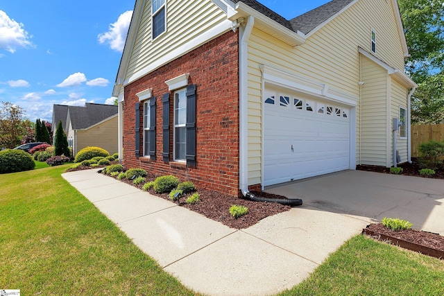 view of home's exterior with concrete driveway, brick siding, an attached garage, a shingled roof, and a yard