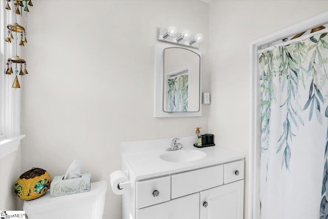 bathroom featuring vanity and toilet