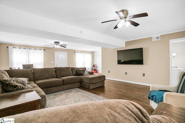 living area with wood finished floors, baseboards, a ceiling fan, and visible vents