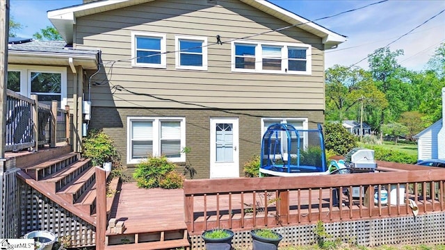 back of property featuring a wooden deck