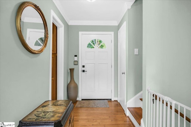 doorway to outside featuring light wood-type flooring, baseboards, and ornamental molding