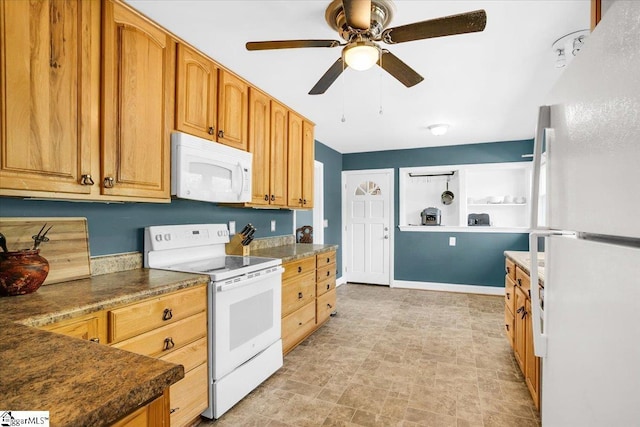 kitchen featuring dark countertops, baseboards, a ceiling fan, and white appliances