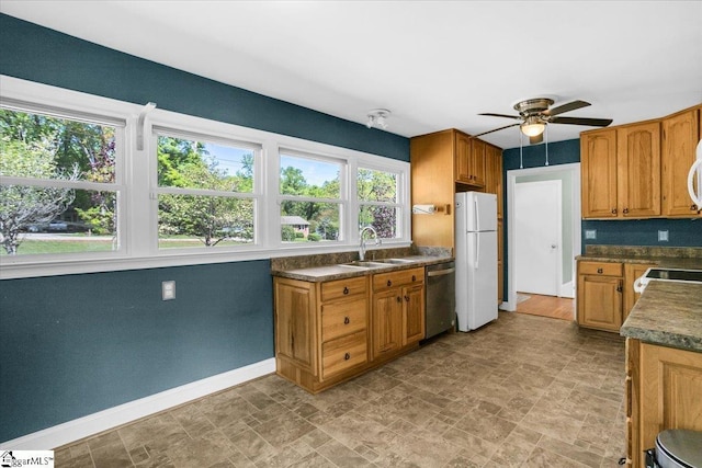 kitchen featuring ceiling fan, baseboards, a healthy amount of sunlight, and white appliances