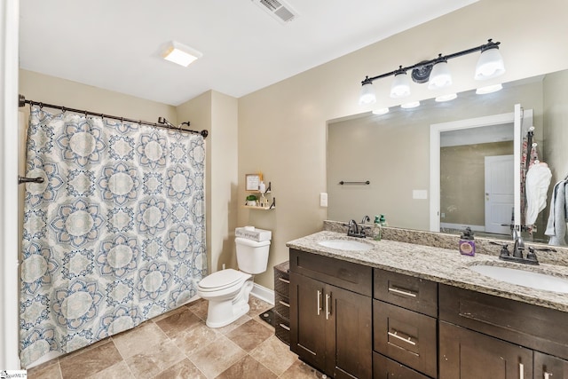 bathroom with toilet, a sink, visible vents, and double vanity