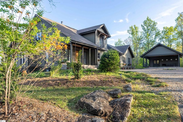 view of home's exterior featuring a carport, gravel driveway, and a shingled roof