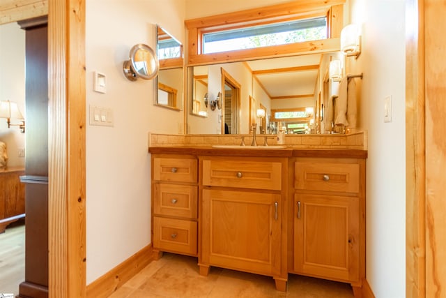 bathroom featuring baseboards and vanity