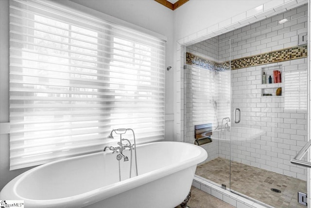 full bath featuring a freestanding tub and a stall shower