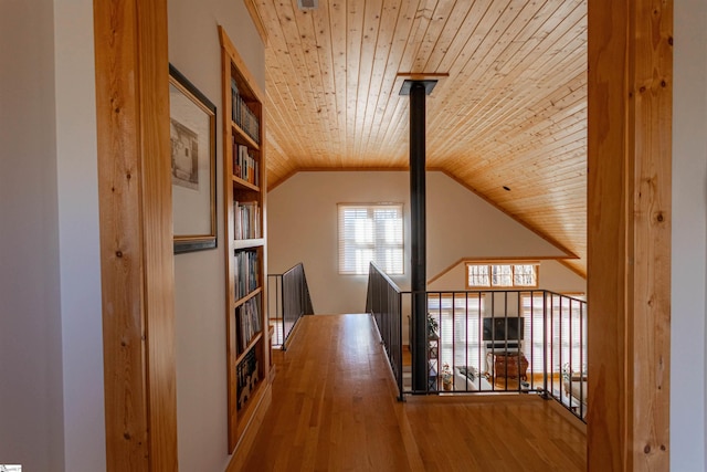 hallway with wood ceiling, vaulted ceiling, and wood finished floors