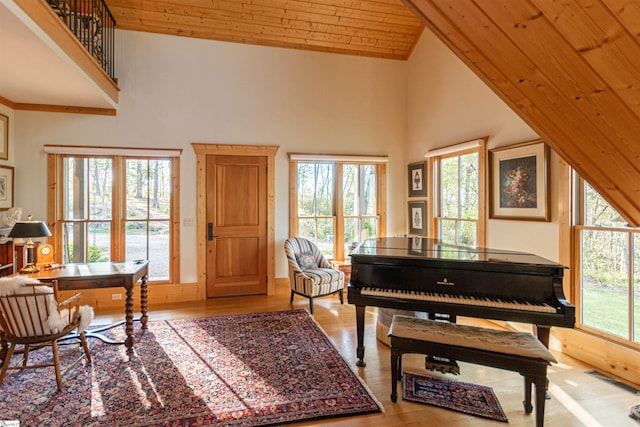sitting room featuring wooden ceiling, wood finished floors, and high vaulted ceiling