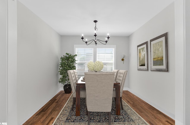 509 Dunbar St, Greenville, SC 29601 - dining area with baseboards, a notable chandelier, and dark wood-style floors