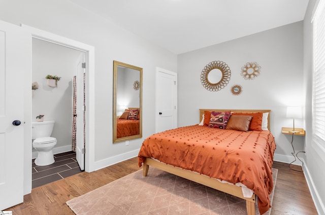 509 Dunbar St, Greenville, SC 29601 - bedroom featuring connected bathroom, baseboards, and wood finished floors