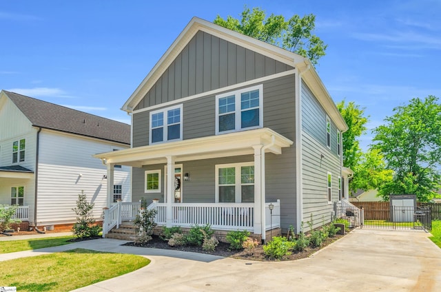 509 Dunbar St, Greenville, SC 29601 - view of front of home featuring board and batten siding, driveway, covered porch, and fence