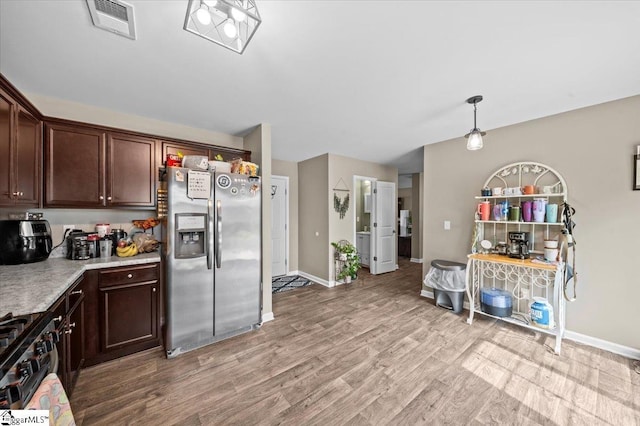 224 Hillendale Way, Pelzer, SC 29669 - kitchen with light countertops, stainless steel fridge, light wood-style flooring, gas range oven, and visible vents
