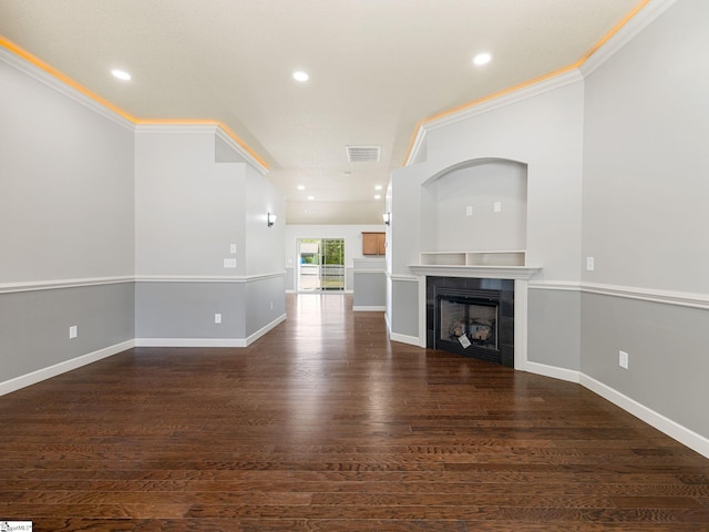 unfurnished living room featuring ornamental molding, a tile fireplace, and recessed lighting
