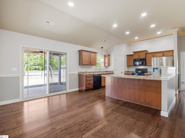 kitchen with brown cabinetry, black appliances, baseboards, and visible vents