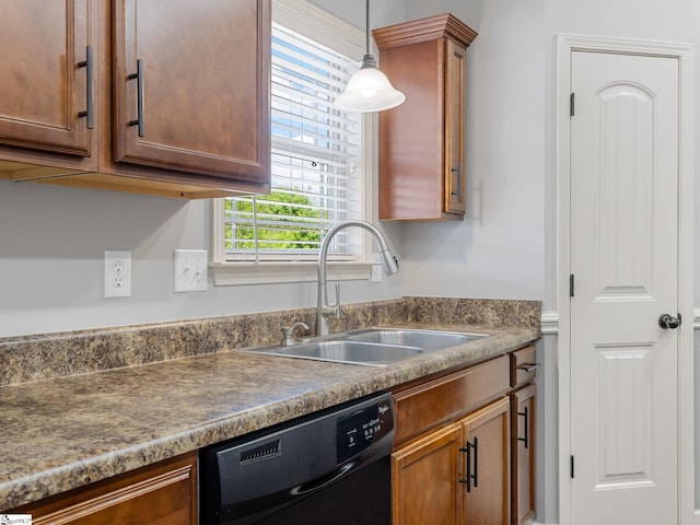 kitchen featuring dishwasher, decorative light fixtures, and a sink