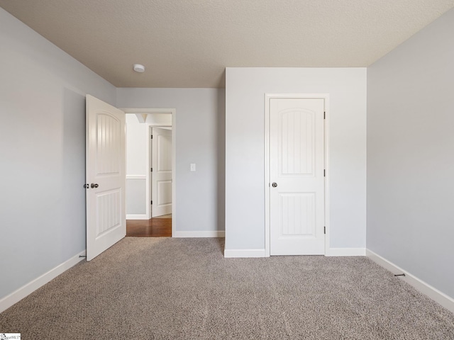 unfurnished bedroom featuring carpet and baseboards