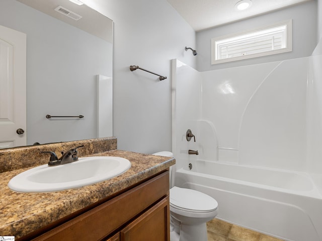 bathroom featuring vanity, toilet, shower / washtub combination, and visible vents