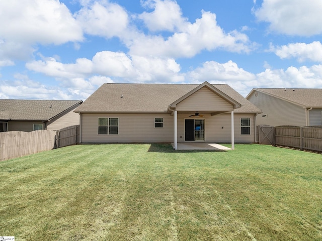 rear view of property with a lawn, a fenced backyard, a patio, and ceiling fan