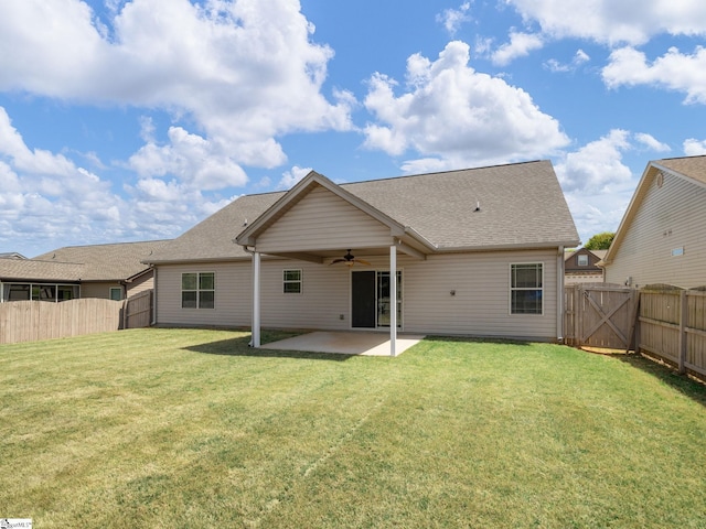 rear view of house with a fenced backyard, a gate, a patio area, ceiling fan, and a yard