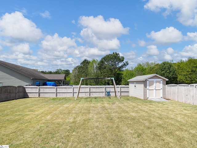 view of yard with a fenced backyard, an outbuilding, and a storage shed