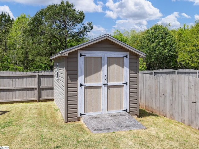 view of shed with a fenced backyard