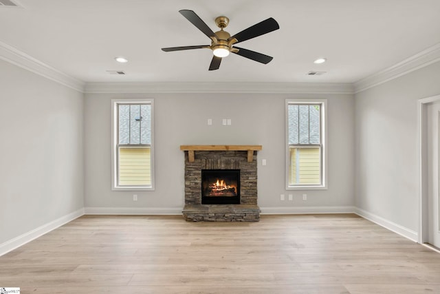 unfurnished living room featuring light wood-style flooring, visible vents, a fireplace, and ornamental molding